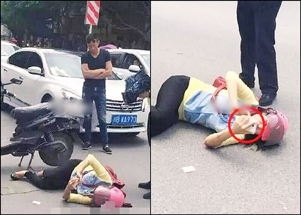 女子遭遇车祸 躺在马路中间玩手机(图)
